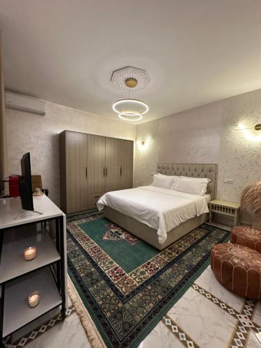 a bedroom with a bed and a tv and a couch at Marrakech Airport in Marrakesh