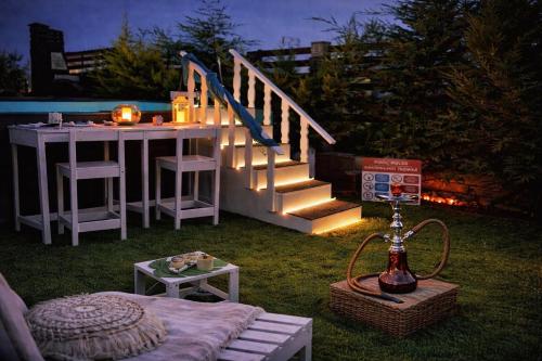 een terras met een tafel en een trap met verlichting bij Heraklia villa sea view pool & jacuzzi in Nea Iraklia