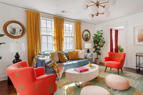 a living room with a blue couch and two red chairs at Lucky Leopard in Atlanta