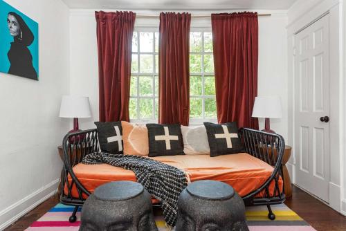 a bed in a room with red curtains and a window at Lucky Leopard in Atlanta