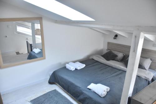 a bedroom with a bed with a large mirror at Fiko Apartment in Niš
