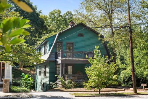 a green house with a balcony on top of it at Lucky Leopard in Atlanta