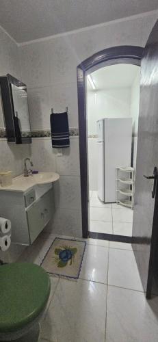 a bathroom with a sink and a refrigerator at Flat Saigon Barra de Maricá Pé na Areia Wi-Fi in Maricá