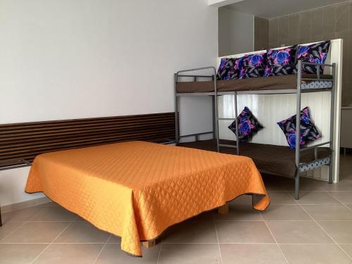 a bedroom with a bed and a shelf with pillows at Fort Apartments in Vila do Porto