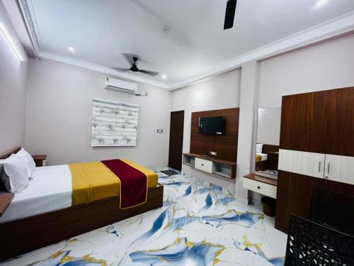 a bedroom with a bed and a tv at Villa D Amour in Pondicherry