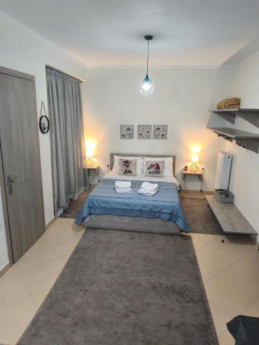 a bedroom with a bed and two towels on it at Alkyona apartments in Kalavrita