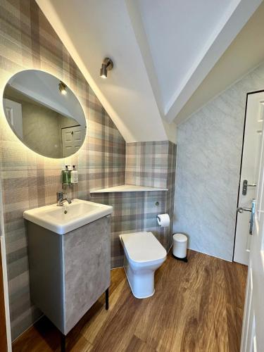 a bathroom with a sink and a toilet at Sheraton Apartments in Fort William