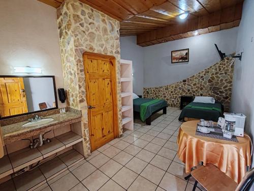 a room with a bathroom with a sink and a mirror at Hotel Cibeles Resort in Heredia
