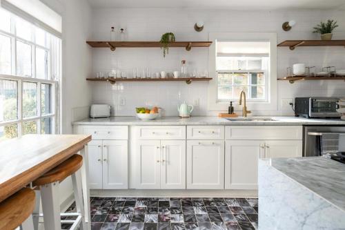 a kitchen with white cabinets and a counter top at Golden Gazelle in Atlanta