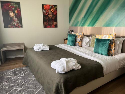 a bedroom with a large bed with towels on it at BE ONE HOTEL Caldas da Rainha - by MHMB Hospitality in Caldas da Rainha