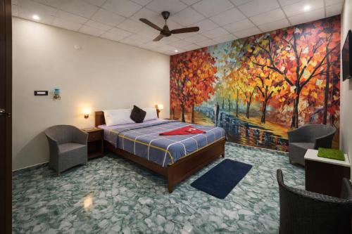 een slaapkamer met een bed en een schilderij aan de muur bij Heaven Stay Resort in Shankerpalli