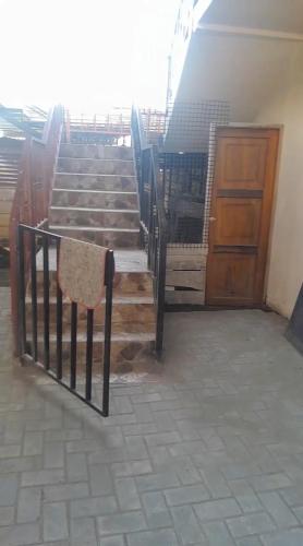 a set of stairs with a gate and a wooden door at Apartamento Rural Vacacional in Cotundo