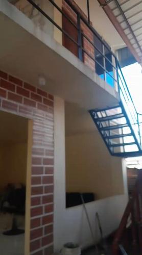 a staircase in a room with a brick wall at Apartamento Rural Vacacional in Cotundo