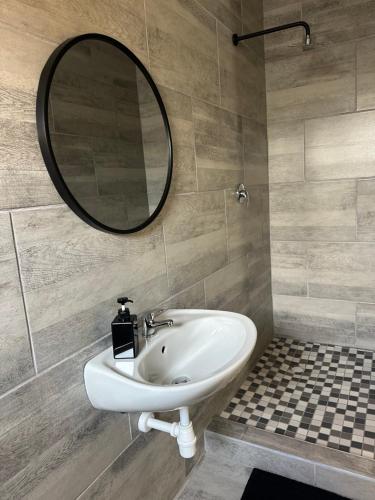 a bathroom with a sink and a mirror at Guesthouse Le Michele in Swakopmund