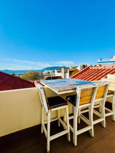 a table and two chairs sitting on a roof at Tree House in Setúbal