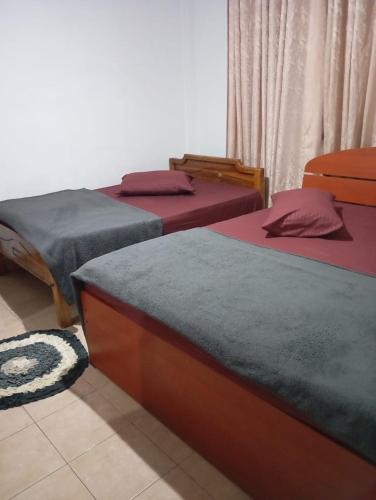 a group of three beds in a room at Mountain View in Bandarawela