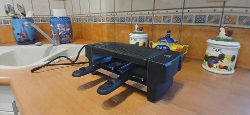 a camera sitting on a counter next to a sink at Entre sel et vignes in Lons-le-Saunier