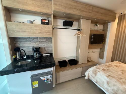 a small kitchen with a sink and a bed at Tiny Spot in Ocaña