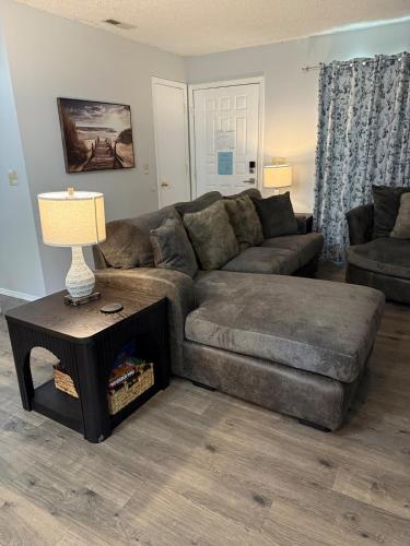 a living room with a couch and a table at Wolf Creek Escape Grove OK in Grove