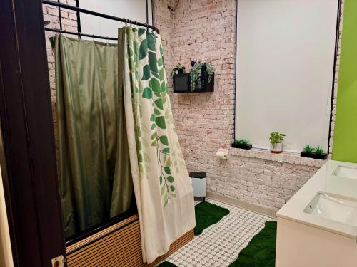 a bathroom with a shower curtain and a sink at Brick City Loft in Newark