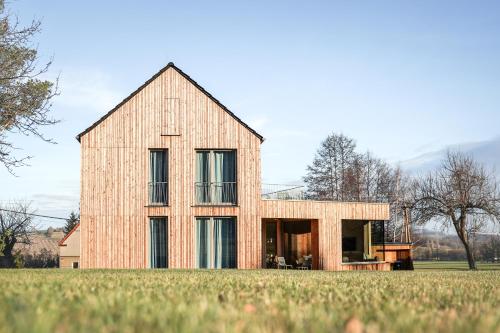 a large brick house on a grassy field at Ferienhaus Weitsicht in Großschönau