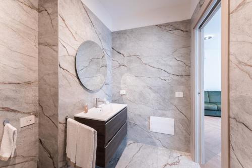 a bathroom with a sink and a mirror at Palazzo Le Giare - Luxury Apartments in Bari