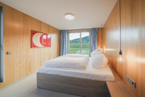 a small bedroom with a bed with a window at Ferienhaus Weitsicht in Großschönau