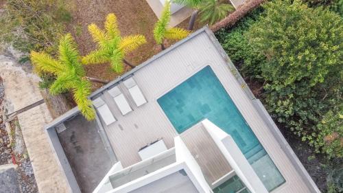 an overhead view of a swimming pool on a house at Sunshine Villa with Optionally Heated Pool 150m above Ocean & Sandy Beach in Estreito da Calheta