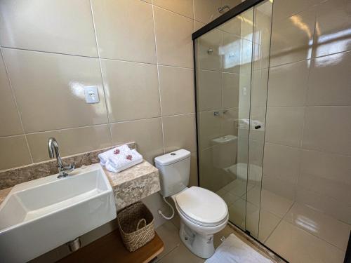 a bathroom with a toilet and a sink and a shower at The house - Casa Coral in Trairi