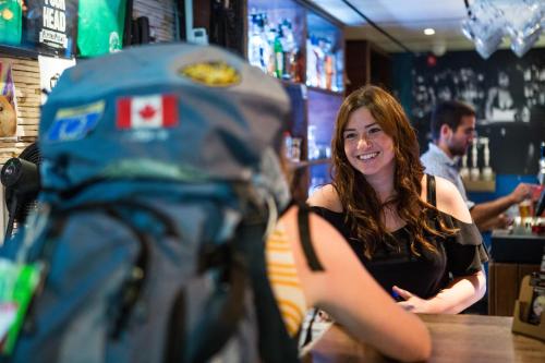 a woman sitting at a counter in a bar at Flying Pig Uptown in Amsterdam