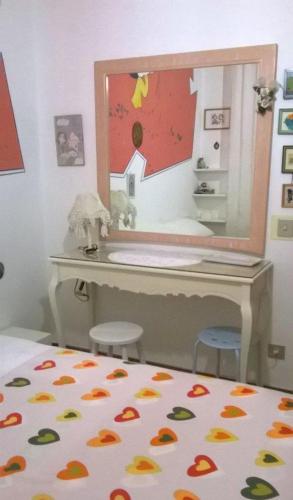 a bedroom with a mirror and a bed with two stools at B&B Amurri Domenica in Grottammare