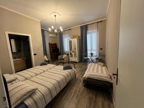 a group of four beds in a room at La Fatina appartamento in Collodi
