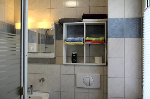 a bathroom with a sink and a towel rack at Pension963 in Crimmitschau