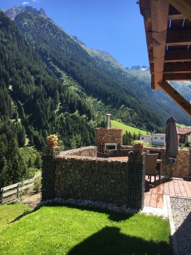 a view from the patio of a house with mountains in the background at Haus Margreiter in Sankt Leonhard im Pitztal