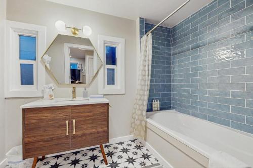 a bathroom with a tub and a sink and a mirror at Saltwind Shores in Moclips