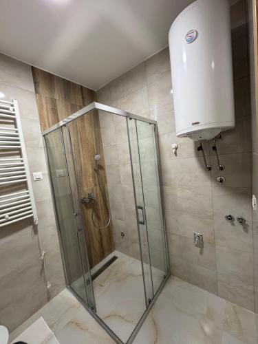 a shower with a glass door in a bathroom at Kalisi Panorama Tornik in Zlatibor