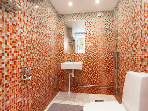a bathroom with a toilet and a sink and a mirror at Stockholm Hostel in Stockholm