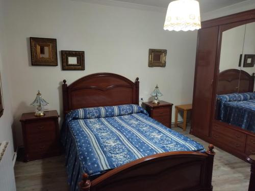 a bedroom with a bed with a blue comforter at Ramon del Xalet in Ibars de Noguera