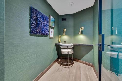 a bathroom with a sink and a counter with a stool at The View - Navy Yard Washington DC in Washington, D.C.