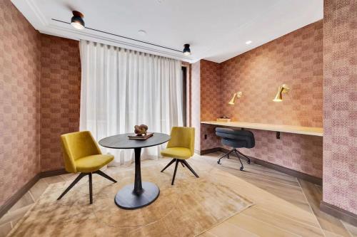 a room with a table and two chairs and a desk at The View - Navy Yard Washington DC in Washington, D.C.