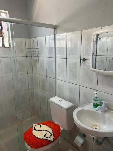 a small bathroom with a toilet and a sink at CASA TEMPORADA PRADO-BA in Prado