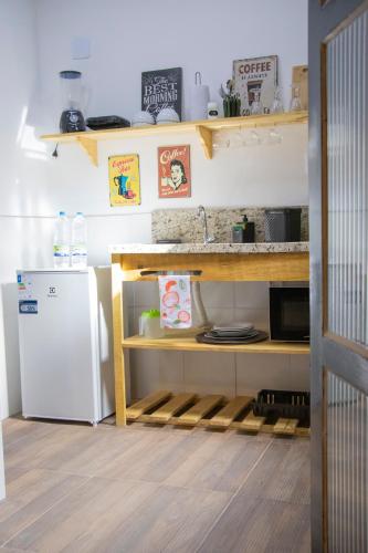 a kitchen with a sink and a refrigerator at Centro Histórico com Garagem - Studio Petrópolis in Petrópolis