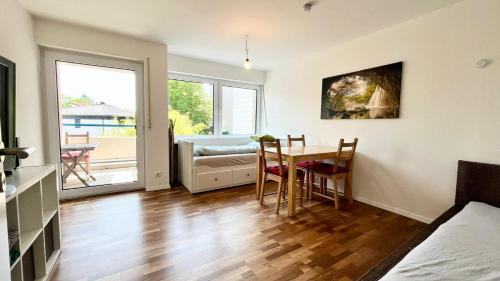 a living room with a table and a dining room at Horizon Apartments in Memmingen