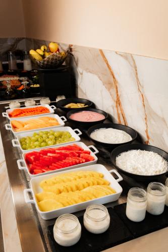 a buffet with several trays of different types of food at Crowne Plaza Merida by IHG in Mérida
