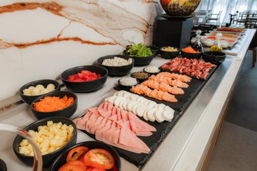 a buffet line with many different types of food at Crowne Plaza Merida by IHG in Mérida