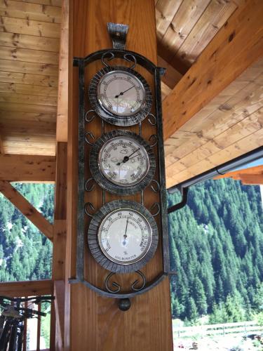 a clock on the side of a wooden wall at Haus Margreiter in Sankt Leonhard im Pitztal