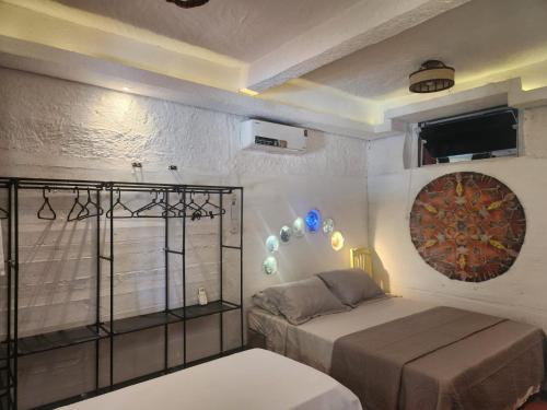 a bedroom with a bed and a window at Imbassaí Pousada Hostel Lujimba in Imbassai