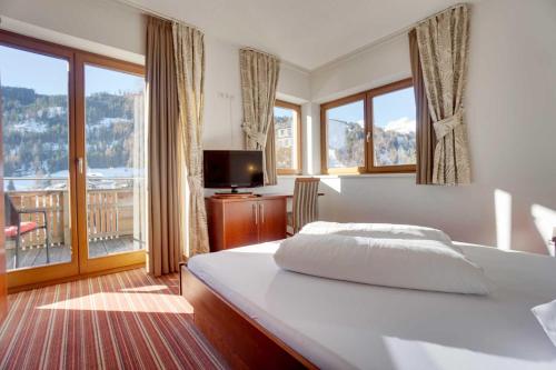 ein Schlafzimmer mit einem großen Bett und einem Balkon in der Unterkunft Aparthotel Philipp in Serfaus