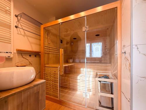 a bathroom with a glass shower and a sink at FORTUNA ORO in montagna in Spormaggiore