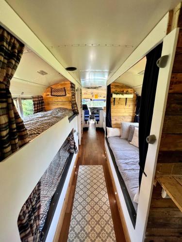 an interior view of an rv with two beds and a couch at Camp Bonnie in Kent